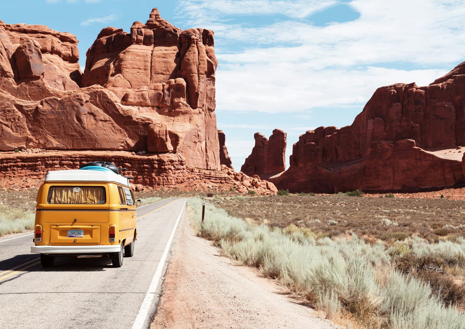 Desert highway through sandstone cliffs at midday